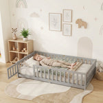 Toddler resting on a natural Montessori floor bed with fence in a forest-themed nursery