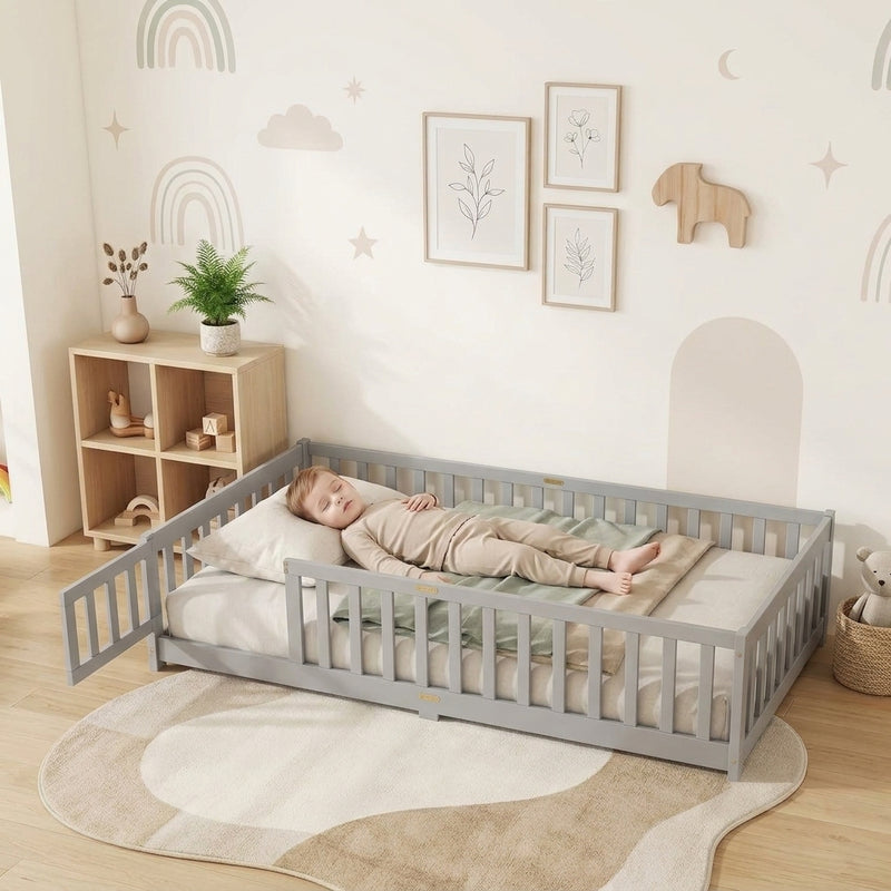 Toddler resting on a natural Montessori floor bed with fence in a forest-themed nursery