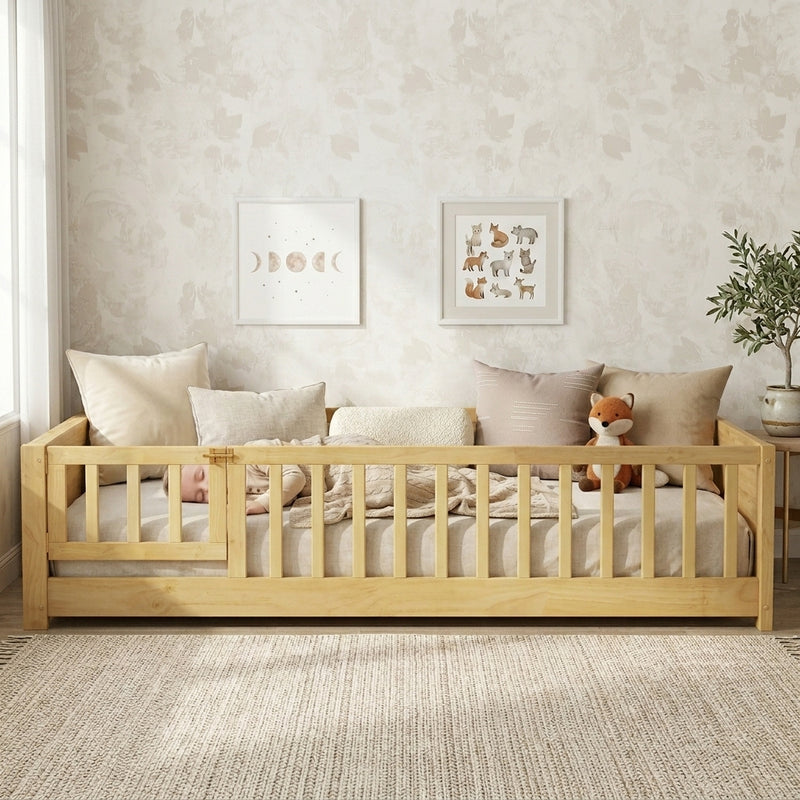 Toddler resting on a natural Montessori floor bed with fence in a forest-themed nursery