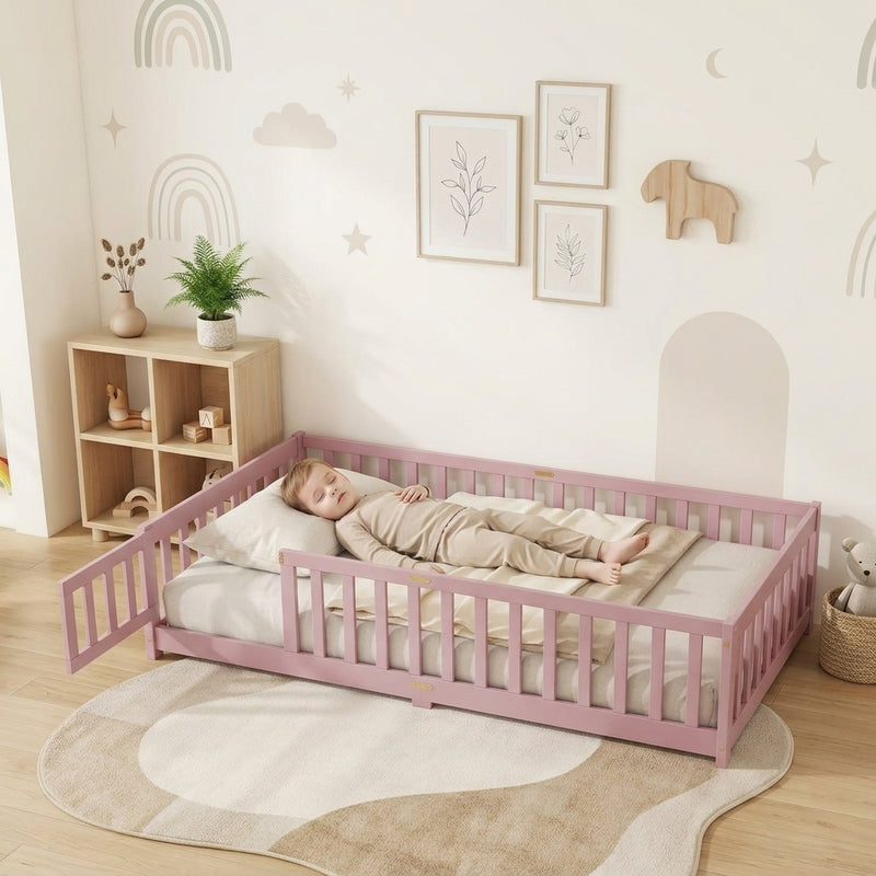 Toddler resting on a natural Montessori floor bed with fence in a forest-themed nursery