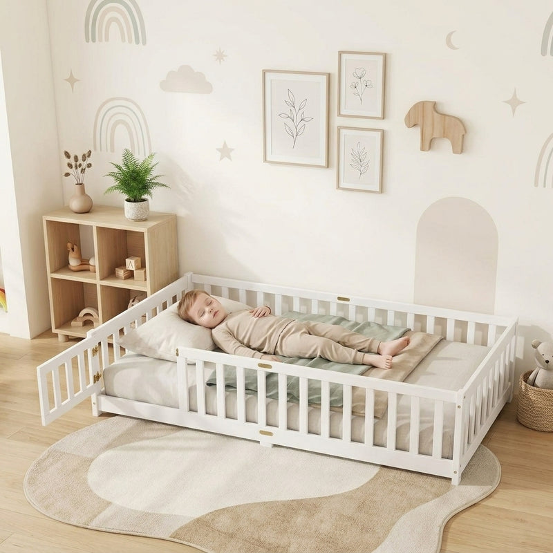 Toddler resting on a natural Montessori floor bed with fence in a forest-themed nursery