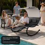 Man relaxing on a navy outdoor chaise lounger with canopy at a poolside gathering