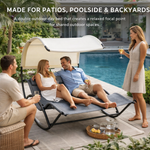 Man relaxing on a navy outdoor chaise lounger with canopy at a poolside gathering
