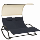 Navy outdoor chaise lounger with canopy, cushion and headrest pillow on a patio