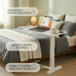 White overbed table with wheels positioned next to bed in bedroom setting