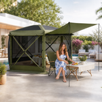 Green pop-up screen gazebo set up beside a pool with an outdoor dining table