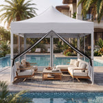 Green pop-up screen gazebo set up beside a pool with an outdoor dining table