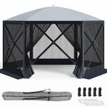 Brown and beige 6-sided pop-up screen tent gazebo set up in a mountain meadow with a table and camping chairs inside