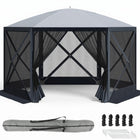 Brown and beige 6-sided pop-up screen tent gazebo set up in a mountain meadow with a table and camping chairs inside