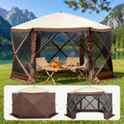 Brown and beige 6-sided pop-up screen tent gazebo set up in a mountain meadow with a table and camping chairs inside