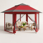 Brown and beige 6-sided pop-up screen tent gazebo set up in a mountain meadow with a table and camping chairs inside