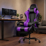 Reclining gaming chair with footrest at a home office desk with dual monitors