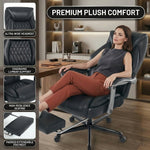 Woman reclining with feet up on the extended footrest of the black massage office chair