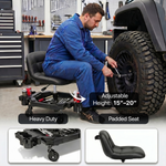 Mechanic seated on a red rolling garage stool adjusting a truck tire with a wrench