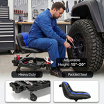 Mechanic seated on a red rolling garage stool adjusting a truck tire with a wrench