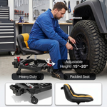 Mechanic seated on a red rolling garage stool adjusting a truck tire with a wrench