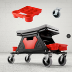 Red and black padded rolling mechanic stool with a divided tool tray and five casters in a garage
