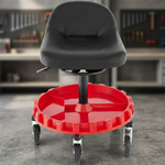 Red and black padded rolling mechanic stool with a divided tool tray and five casters in a garage