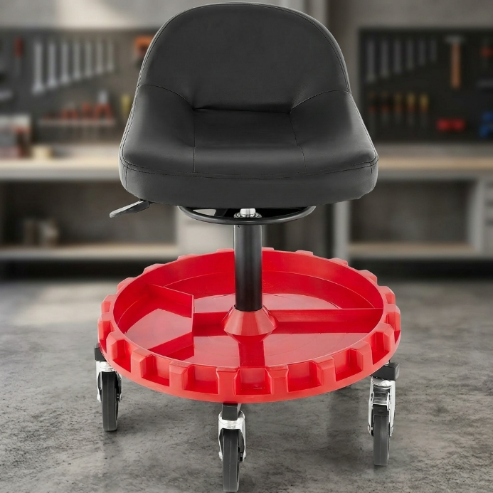 Red and black padded rolling mechanic stool with a divided tool tray and five casters in a garage