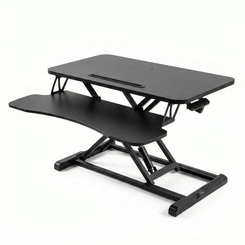 Black standing desk converter shown raised to standing height with keyboard tray