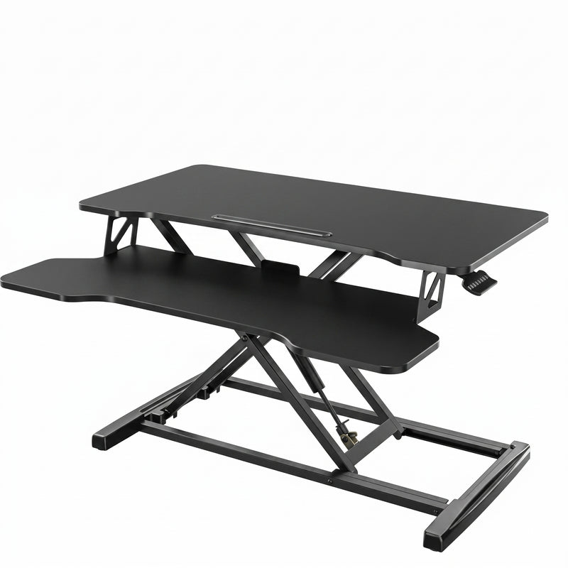 Black standing desk converter shown raised to standing height with keyboard tray