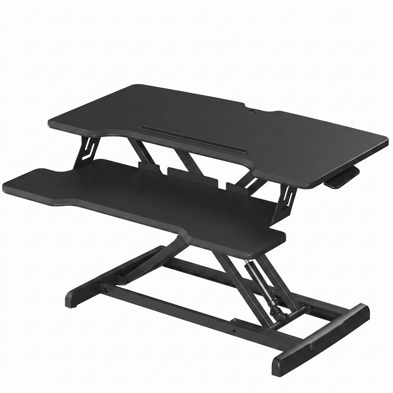Black standing desk converter shown raised to standing height with keyboard tray extended
