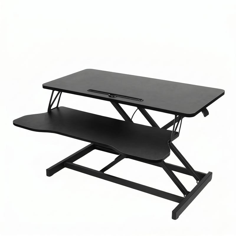 Black standing desk converter shown raised to standing height with keyboard tray extended