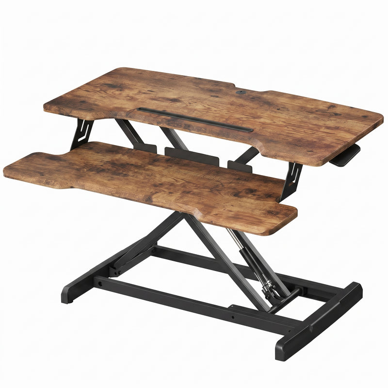 Black standing desk converter shown raised to standing height with keyboard tray extended