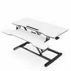 Black standing desk converter shown raised to standing height with keyboard tray