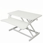 Black standing desk converter shown raised to standing height with keyboard tray extended