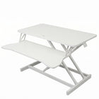 Black standing desk converter shown raised to standing height with keyboard tray