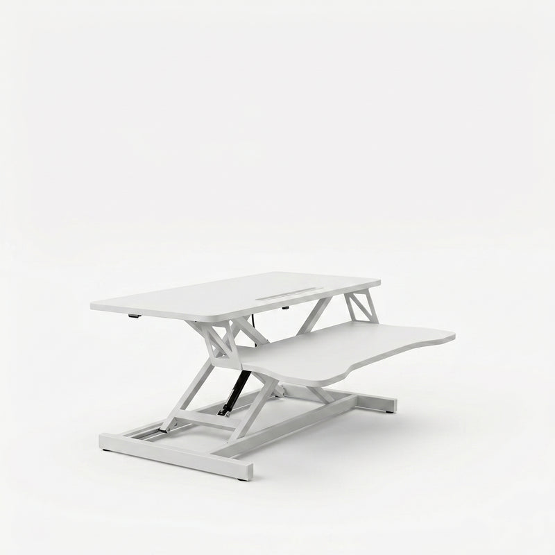 Black standing desk converter shown raised to standing height with keyboard tray