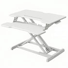 Black standing desk converter shown raised to standing height with keyboard tray