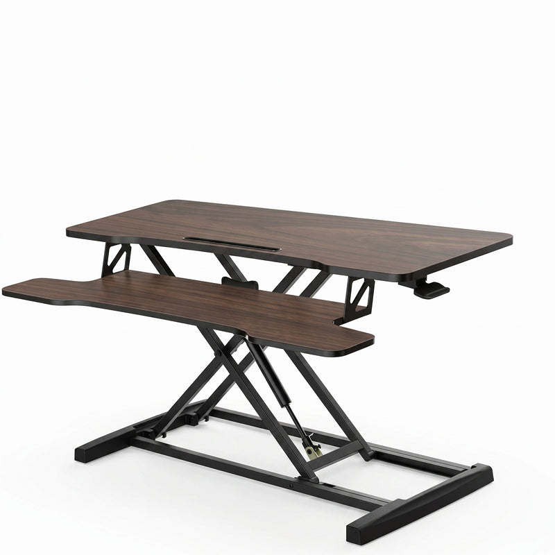 Black standing desk converter shown raised to standing height with keyboard tray extended