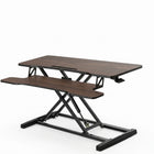 Black standing desk converter shown raised to standing height with keyboard tray