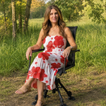 Hunter using camo swivel hunting chair with binoculars in a field