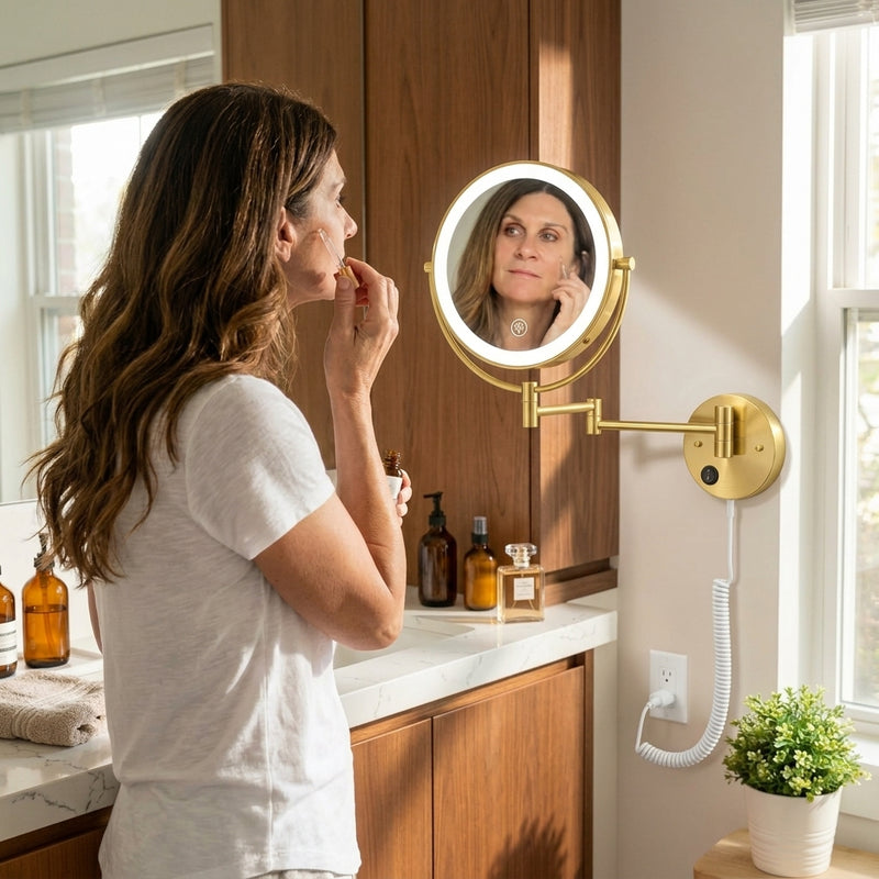 Woman applying makeup using a wall-mounted LED magnifying mirror at a bathroom vanity