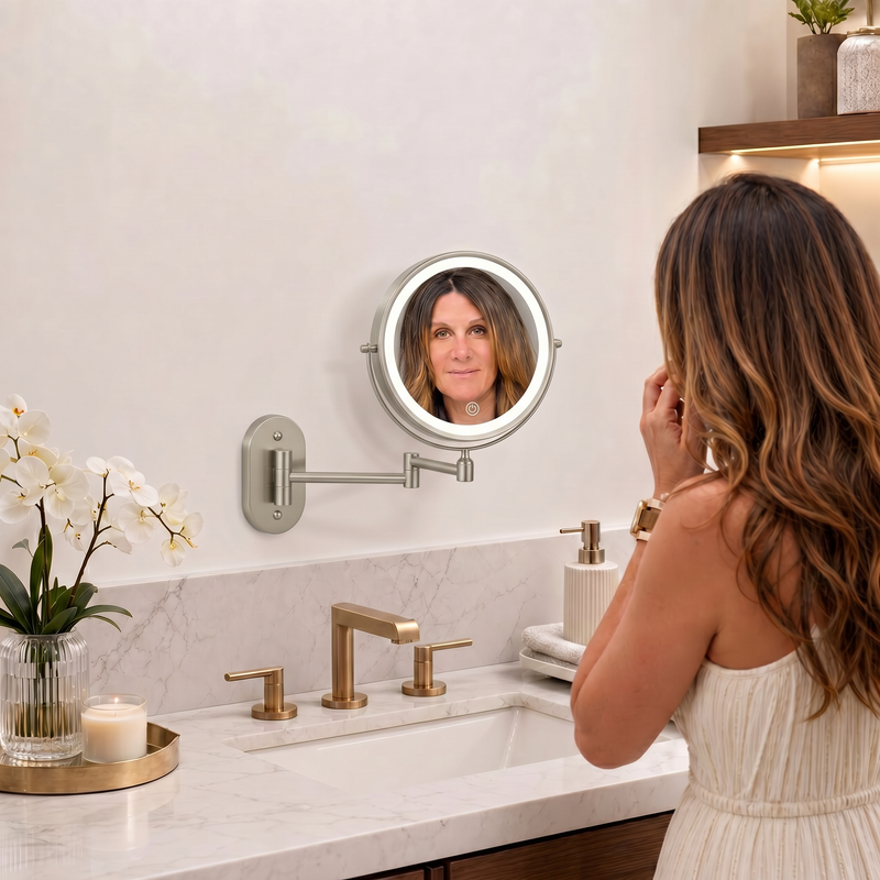 Woman adjusting a wall mounted LED magnifying makeup mirror in a bathroom vanity setting