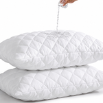 Quilted waterproof mattress protector on a bed in a bright bedroom