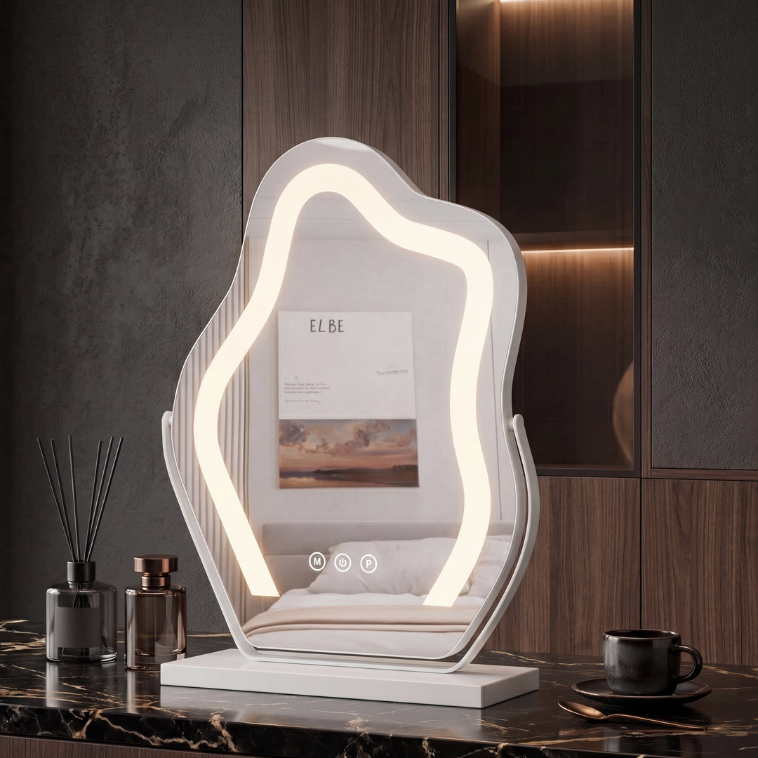 White wavy-shaped LED vanity mirror with warm halo lighting and touch controls on a white base atop a black marble vanity