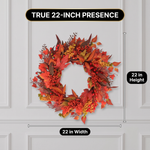 Woman hanging an artificial fall wreath on a front door